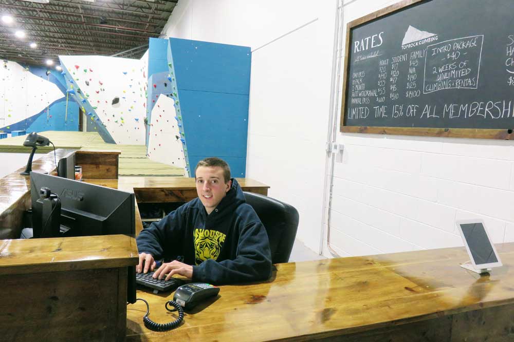 Kevin Allen working the desk at Toprock Climbing Gym